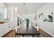 Open-concept dining area featuring a large dark wood table and plush white chairs at 2511 N Grady Ave # 41, Tampa, FL 33607