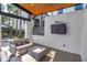 Comfortable outdoor patio seating area with a covered ceiling and mounted television at 2511 N Grady Ave # 41, Tampa, FL 33607