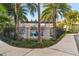 Community pool area surrounded by lush landscaping and palm trees at 2511 N Grady Ave # 41, Tampa, FL 33607