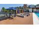 Poolside deck with lounge chairs, patio furniture, and view of community pond at 2511 N Grady Ave # 41, Tampa, FL 33607