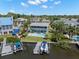A high angle shot of the home with a boat dock and pool, showcasing waterfront living at its best at 261 Kentucky Ave, Crystal Beach, FL 34681