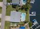 Overhead aerial view of the property showing the pool, boat dock and seawall with quick access to open water at 261 Kentucky Ave, Crystal Beach, FL 34681
