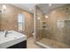 Modern bathroom featuring a glass-enclosed shower with tan stone tile and a sleek floating sink at 261 Kentucky Ave, Crystal Beach, FL 34681