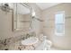 Modern bathroom featuring a marble countertop, white cabinets, and tile shower at 261 Kentucky Ave, Crystal Beach, FL 34681