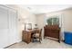 Bedroom featuring a desk, dresser, white closet, window and light wood flooring at 261 Kentucky Ave, Crystal Beach, FL 34681