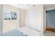 Bedroom featuring a bed, closet, window with coverings, and light wood floors at 261 Kentucky Ave, Crystal Beach, FL 34681