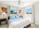 Bedroom featuring a large bed, bedside tables, two windows and a ceiling fan at 261 Kentucky Ave, Crystal Beach, FL 34681