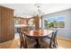 Lovely dining area featuring a wood table, modern lighting, and view to the kitchen at 261 Kentucky Ave, Crystal Beach, FL 34681
