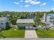 Charming home with well-manicured lawn, mature landscaping, a two-car garage and a lengthy concrete driveway at 261 Kentucky Ave, Crystal Beach, FL 34681
