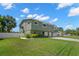 The manicured lawn and white fence enhance curb appeal, complementing the home's exterior at 261 Kentucky Ave, Crystal Beach, FL 34681