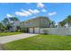 The home shows a manicured lawn and two car garage enhancing its curb appeal and functionality at 261 Kentucky Ave, Crystal Beach, FL 34681
