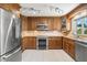 Modern kitchen with stainless steel appliances, stylish lighting and wood cabinetry at 261 Kentucky Ave, Crystal Beach, FL 34681
