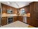 Well-equipped kitchen with stainless steel appliances and warm wood cabinetry at 261 Kentucky Ave, Crystal Beach, FL 34681