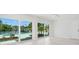 Bright living room with expansive glass doors, seamlessly connecting indoor spaces to the backyard pool area at 261 Kentucky Ave, Crystal Beach, FL 34681
