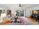 Comfortable living room with plush chairs, ceiling fan, and sliding doors to a balcony at 261 Kentucky Ave, Crystal Beach, FL 34681