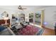Comfortable seating area with plush chairs, hardwood floors, and access to a balcony at 261 Kentucky Ave, Crystal Beach, FL 34681