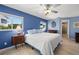 Comfortable main bedroom with natural light, ceiling fan, and a full ensuite bathroom at 261 Kentucky Ave, Crystal Beach, FL 34681