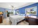 Bright main bedroom with waterfront views, ceiling fan, and access to a balcony at 261 Kentucky Ave, Crystal Beach, FL 34681