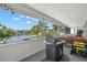 Enclosed patio featuring an outdoor grill, water views and comfortable seating area at 261 Kentucky Ave, Crystal Beach, FL 34681