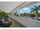 Covered patio area with chairs showcasing expansive water views at 261 Kentucky Ave, Crystal Beach, FL 34681