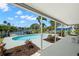 Inviting pool area with mature landscaping and beautiful water views at 261 Kentucky Ave, Crystal Beach, FL 34681
