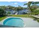 Above ground shot of the beautiful swimming pool overlooking the water and boat docks at 261 Kentucky Ave, Crystal Beach, FL 34681