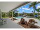 Landscaped pool area with waterfront views and ample lounging space at 261 Kentucky Ave, Crystal Beach, FL 34681