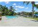 Outdoor pool with spacious patio and views of tropical landscaping, water and boat dock at 261 Kentucky Ave, Crystal Beach, FL 34681