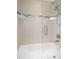 Modern bathroom with a bathtub/shower combination enclosed in a glass door and designer tile surround at 261 Kentucky Ave, Crystal Beach, FL 34681