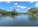 Scenic waterfront view showcasing the calm, serene water and lush tropical landscaping of the surrounding properties at 261 Kentucky Ave, Crystal Beach, FL 34681