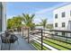 Serene balcony view with modern seating, overlooking lush greenery and a charming neighborhood street at 2758 5Th S Ave, St Petersburg, FL 33712