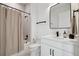 Bathroom featuring modern fixtures, a sleek mirror, vanity sink, and a shower with tan colored curtains at 2758 5Th S Ave, St Petersburg, FL 33712