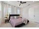 Stylish bedroom with a plush bed, modern ceiling fan and well-lit windows at 2758 5Th S Ave, St Petersburg, FL 33712