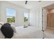 Bedroom with white walls, two large windows, ceiling fan, and access to an ensuite bathroom at 2758 5Th S Ave, St Petersburg, FL 33712