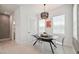 Well-lit dining area with a modern chandelier, table with clear chairs, and a concrete wall at 2758 5Th S Ave, St Petersburg, FL 33712