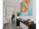 Stylish entryway featuring polished concrete floors, modern console table with artistic decor, and a staircase at 2758 5Th S Ave, St Petersburg, FL 33712