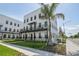 Modern, multi-story building with black balconies, lush landscaping, and a tall palm tree on a clear, sunny day at 2758 5Th S Ave, St Petersburg, FL 33712