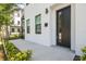 Stylish front entrance featuring a modern black door, clean white exterior, and manicured landscaping at 2758 5Th S Ave, St Petersburg, FL 33712