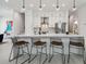 Modern kitchen with breakfast bar seating, stainless appliances, and sleek white cabinets at 2758 5Th S Ave, St Petersburg, FL 33712