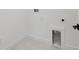 A simple laundry room with modern hookups, a drain, tile floors, and crisp white paint at 2758 5Th S Ave, St Petersburg, FL 33712