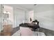 Bright office space with modern desk, pink chair, and view of attached half-bath, featuring white-on-white design at 2758 5Th S Ave, St Petersburg, FL 33712