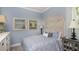 Comfortable bedroom featuring neutral blue walls, an ornate headboard, and matching bedside tables at 29807 Imperati Blvd, Wesley Chapel, FL 33543