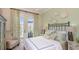 Cozy bedroom featuring a comfortable bed, stylish decor, and access to a private outdoor patio at 29807 Imperati Blvd, Wesley Chapel, FL 33543