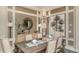 Formal dining room featuring a wooden table, neutral chairs and unique art at 29807 Imperati Blvd, Wesley Chapel, FL 33543
