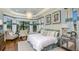 Inviting main bedroom with tray ceilings, hardwood floors and large windows for natural light at 29807 Imperati Blvd, Wesley Chapel, FL 33543