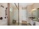 Elegant bathroom featuring a tiled shower with a frameless glass enclosure and modern fixtures at 29825 Imperati Blvd, Wesley Chapel, FL 33543