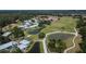 Aerial view of a golf course community with manicured lawns and ponds at 29903 Baywood Ln, Wesley Chapel, FL 33543