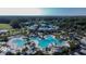 Aerial view showcasing a large pool, surrounding buildings, and lush landscaping in community at 29903 Baywood Ln, Wesley Chapel, FL 33543