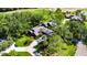 Aerial view of a well-maintained home featuring lush landscaping and a long driveway at 29903 Baywood Ln, Wesley Chapel, FL 33543