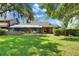 Spacious backyard featuring a screened lanai and lush green lawn at 29903 Baywood Ln, Wesley Chapel, FL 33543